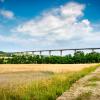 Viaduct across landscape with fields and hills