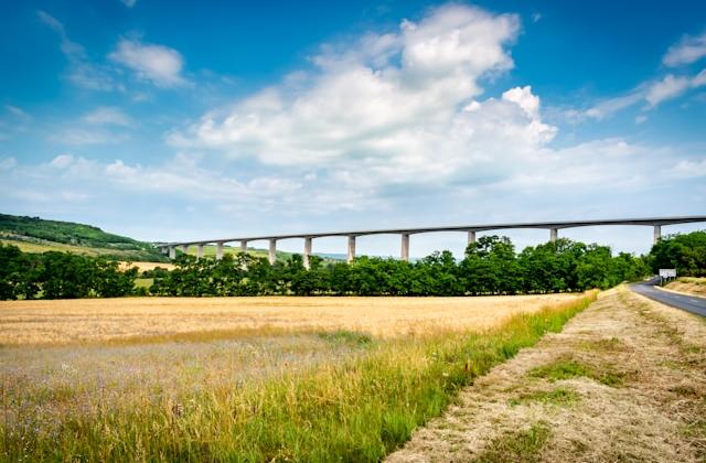 Viaduct across landscape with fields and hills