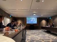 Delegates from Tajikistan sitting in a row at a conference table