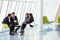 Businesspeople Having Meeting In Modern Office