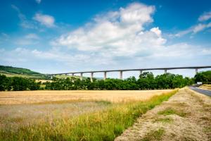 Viaduct across landscape with fields and hills